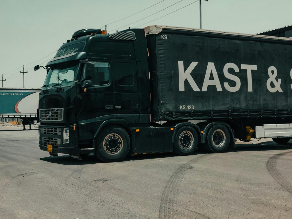 pexels-photo-12418932-12418932 A large industrial truck parked in an urban setting, showcasing transportation industry visuals.